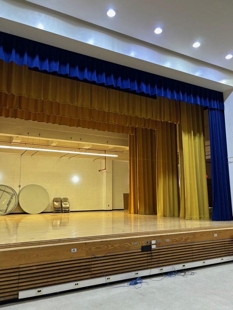 Auditorium stage with new blue and gold curtains