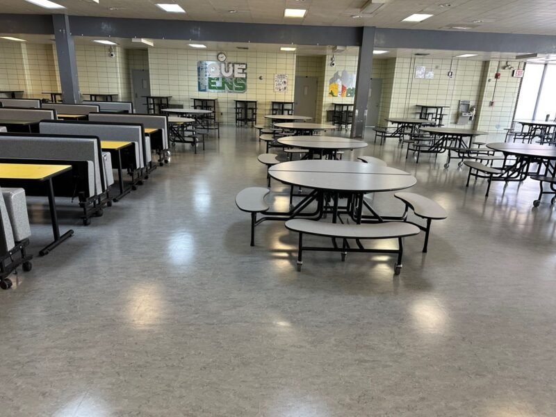 Cafeteria with long table rows and round tables