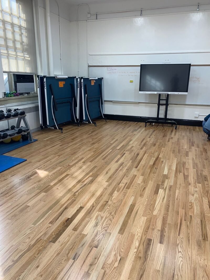 Fitness room with oak floor, table tennis tables and display screen