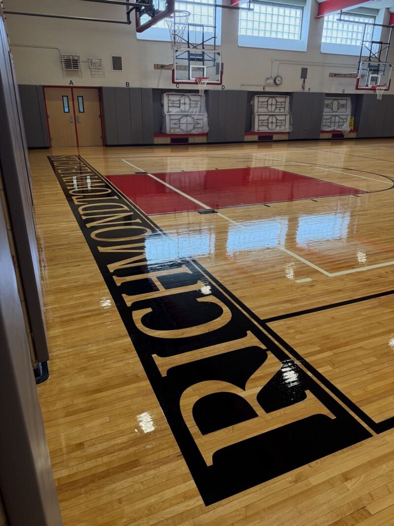 High-gloss gymnasium floor with red key and painted lettering