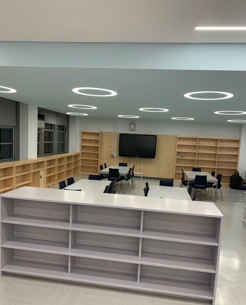 Library with ring lights, maple shelving and study tables