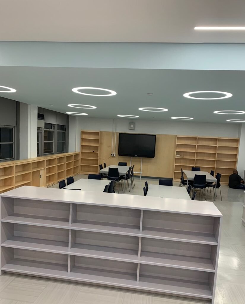 Library with ring lights, maple shelving and study tables