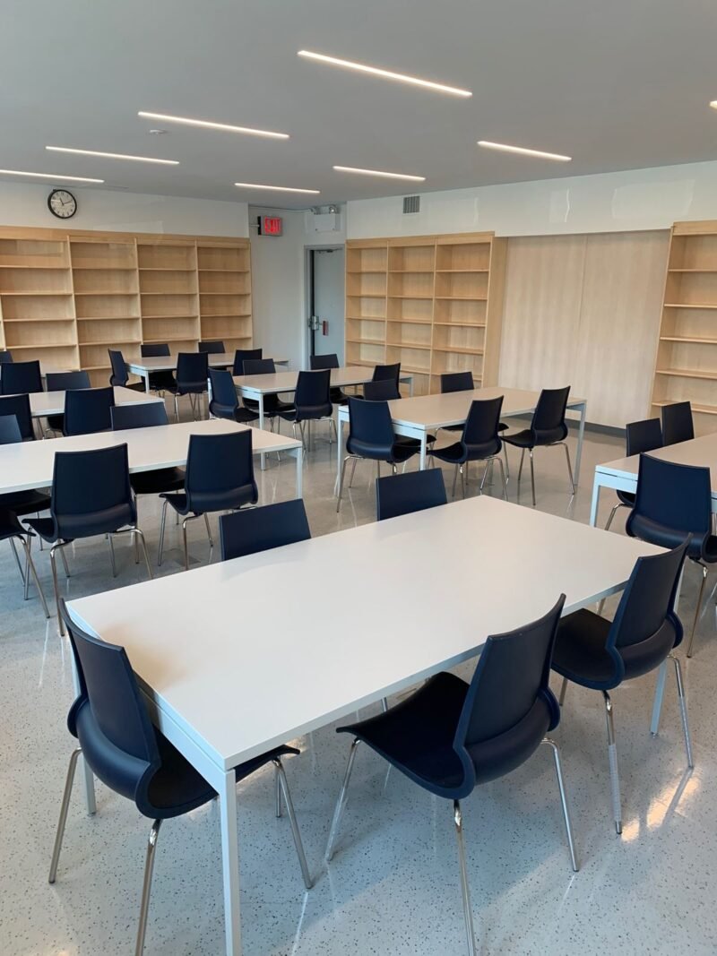 Reading room with white study tables and navy chairs